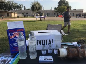 Table with nonpartisan voting outreach and education materials and information on drinking water in California. Photo by Community Water Center.