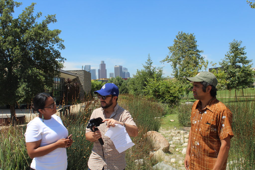 Three staff members from OurWaterLA and Latino Outdoors discussing green stormwater infrastructure at the Los Angeles State Historic Park in 2019. Photo by OurWaterLA.