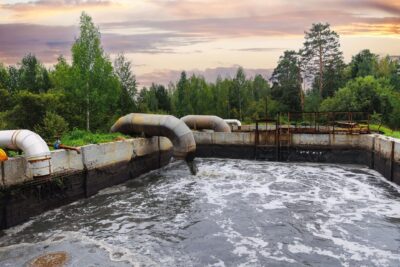 Pipes with waste water of industry is discharged into tank of treatment plant